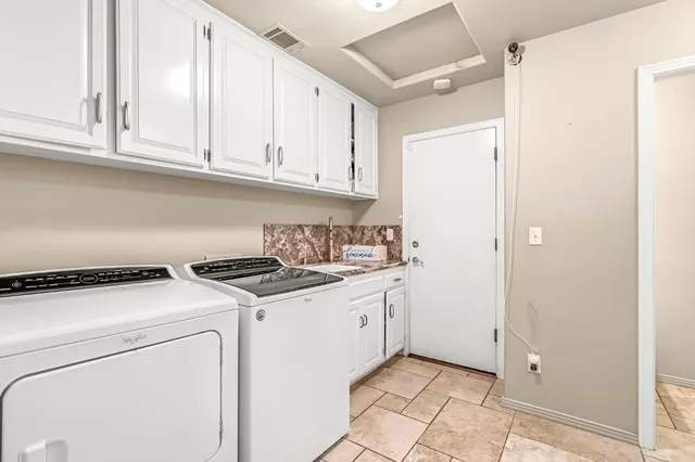 a kitchen with a stove top oven and cabinets