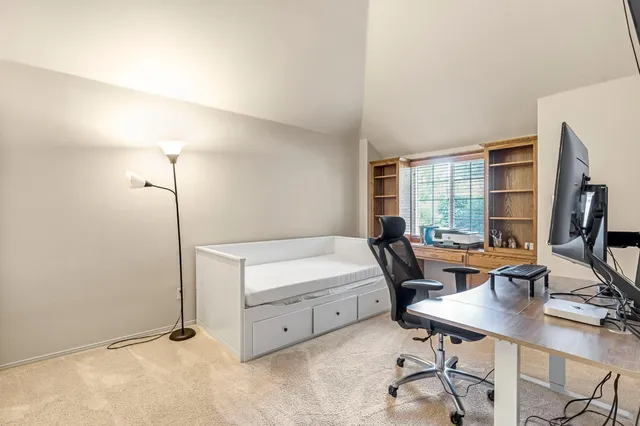 a bathroom with a bathtub and chair
