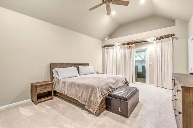 a spacious bedroom with a bed and a flat screen tv