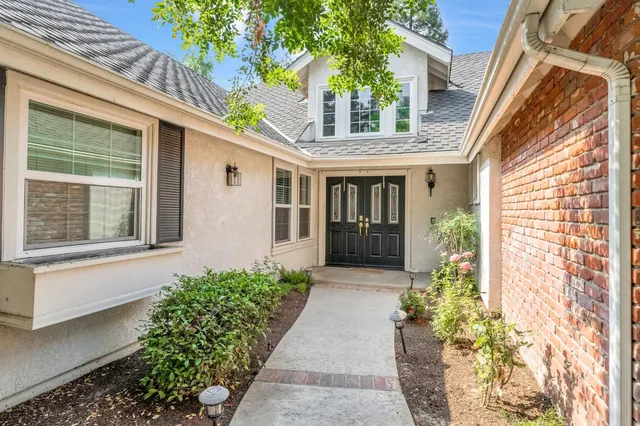 a view of a house with potted plants