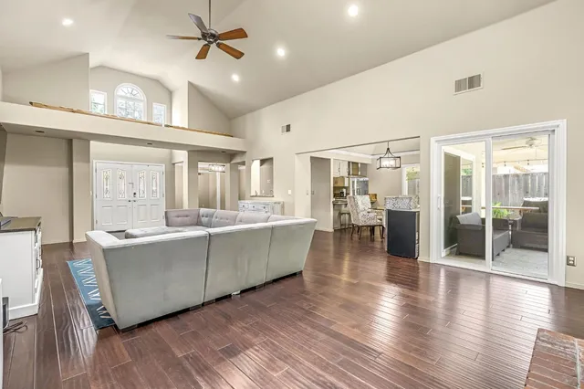a kitchen with stainless steel appliances granite countertop a stove and wooden floors