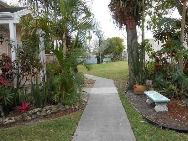 a kitchen with granite countertop a refrigerator and a sink