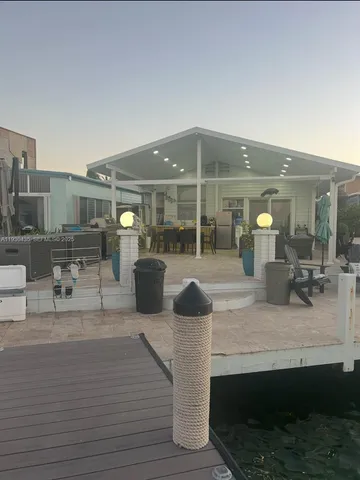 a living room with furniture a flat screen tv and a table