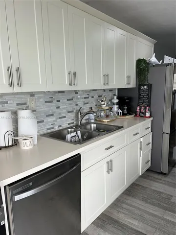 a kitchen with stainless steel appliances granite countertop a stove and a sink