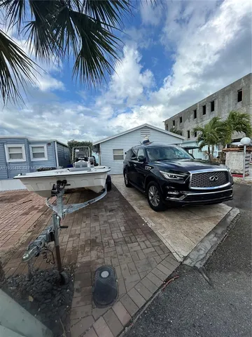 a kitchen with stainless steel appliances a stove a sink a refrigerator a microwave and cabinets