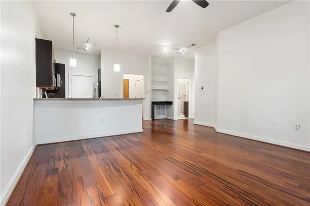 a view of a kitchen with wooden floor and a sink