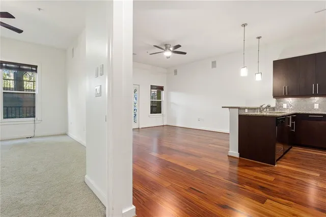 a view of a kitchen with a sink and wooden floor