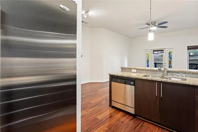 a view of kitchen with granite countertop cabinets and wooden floor