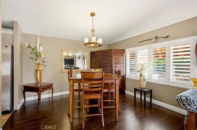 a living room with furniture a rug and a dining table