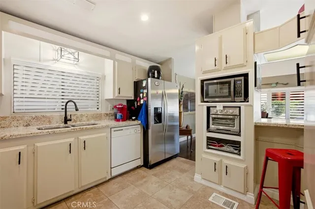 a kitchen with stainless steel appliances granite countertop a sink stove and cabinets