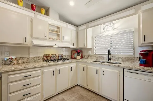 a kitchen with stainless steel appliances kitchen island wooden cabinets and stove top oven