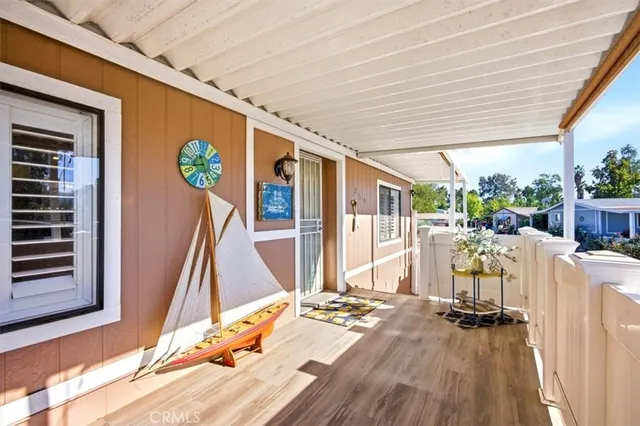 a dinning room with furniture entryway and wooden floor