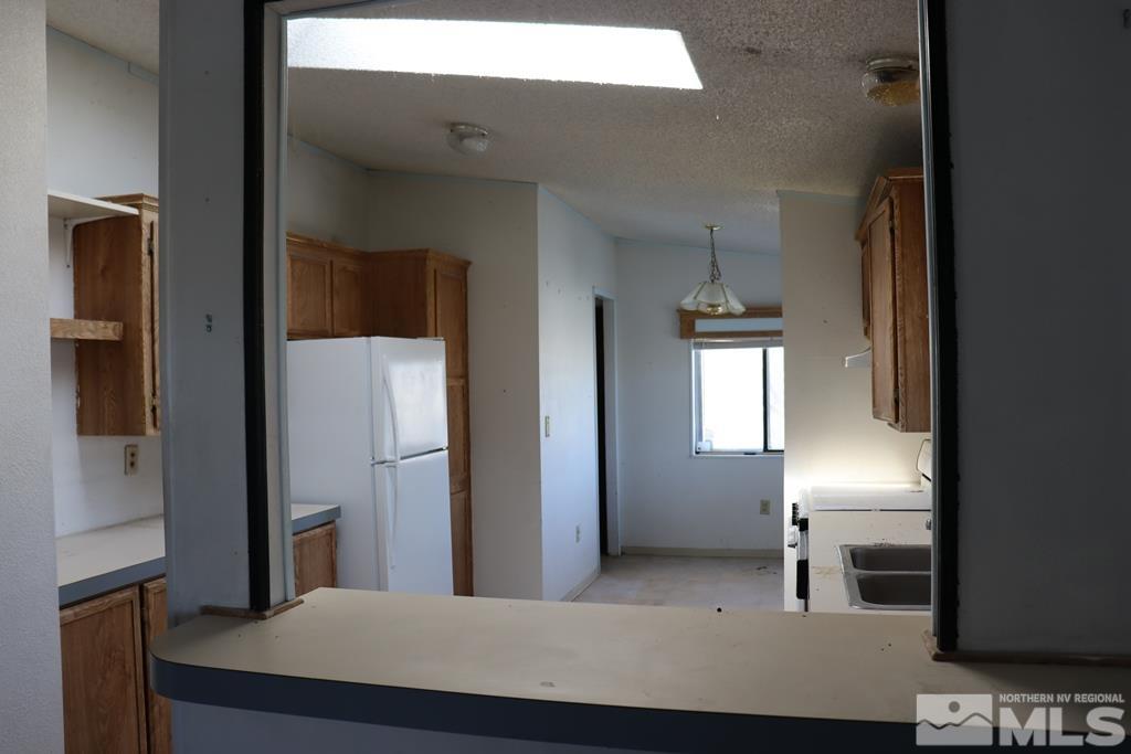 270 McNeil Road Winnemucca, NV 89445 - Photo 3 of 21 a view of kitchen and hallway with windows