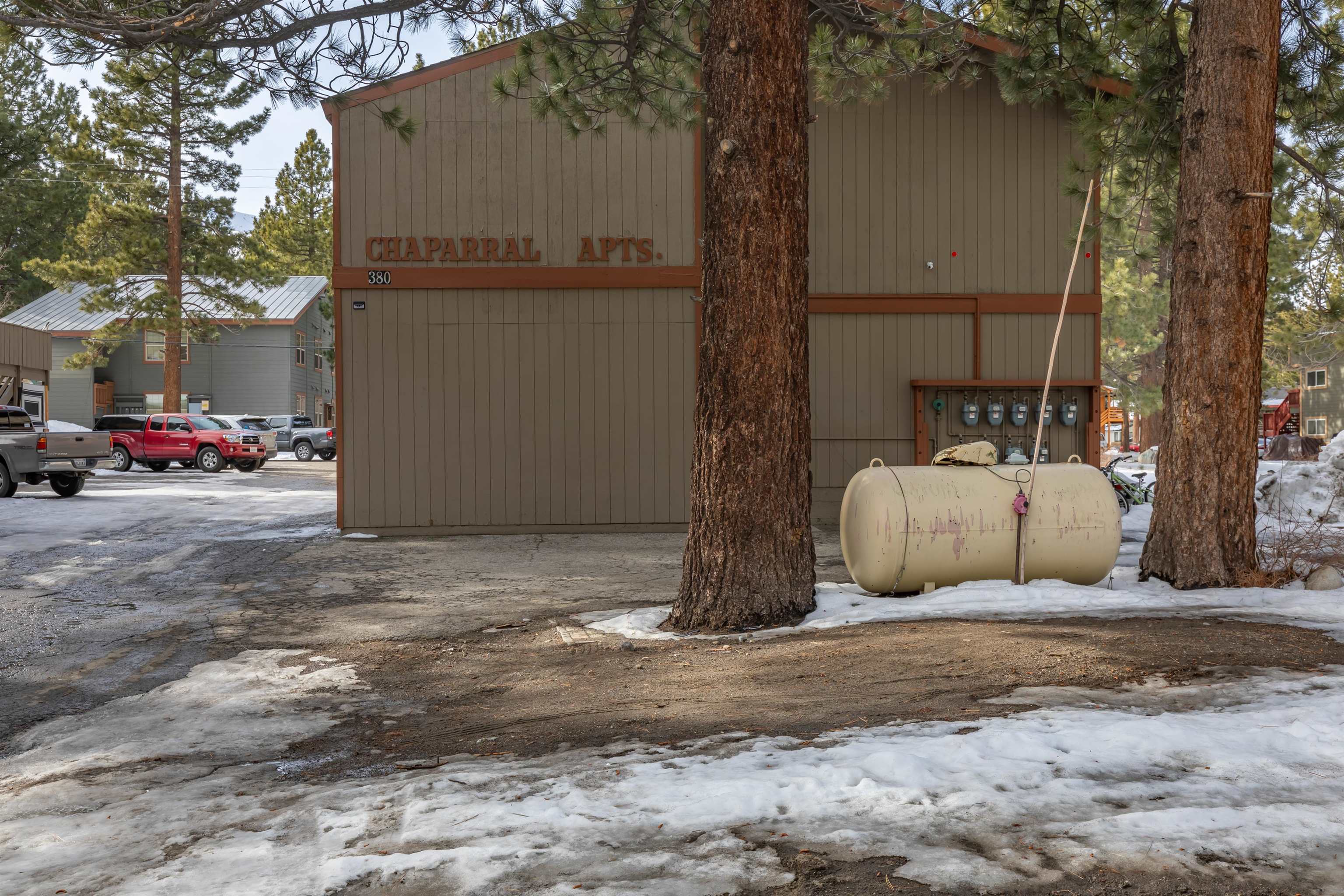 380 Chaparral Road Mammoth Lakes, CA 93546 - Photo 3 of 11 a white house that has a tree in front of it