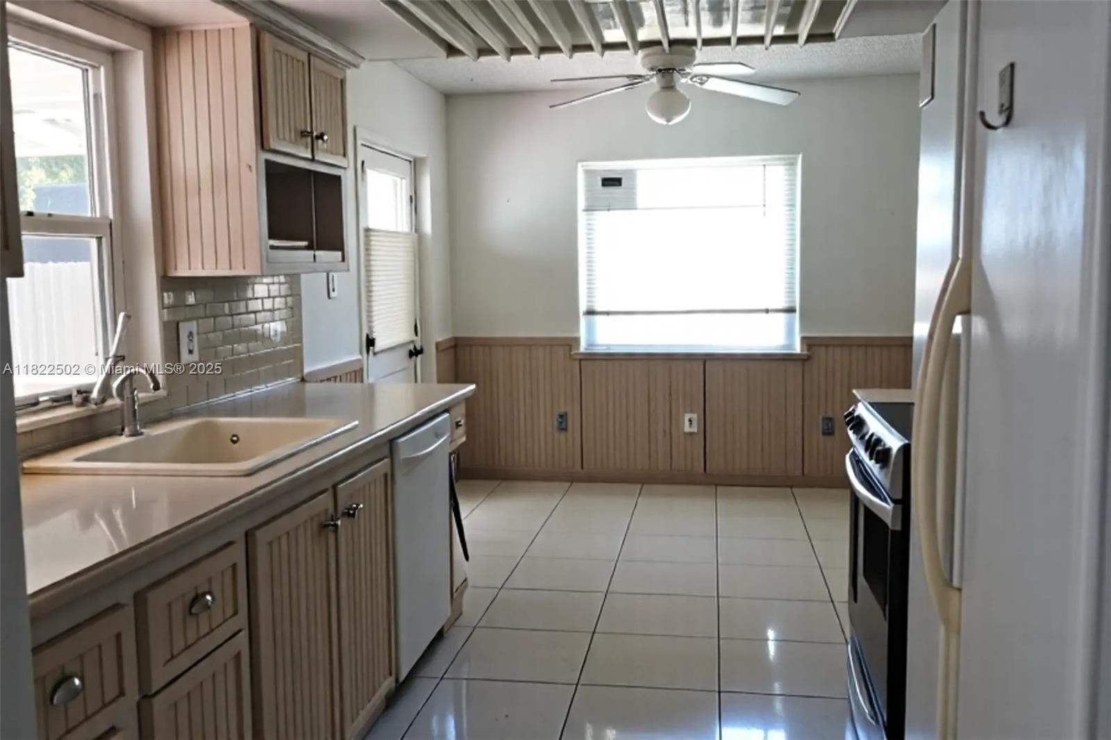 22115 Southwest 58th Avenue Boca Raton, FL 33428 - Photo 13 of 18 a kitchen with a sink a stove and a refrigerator