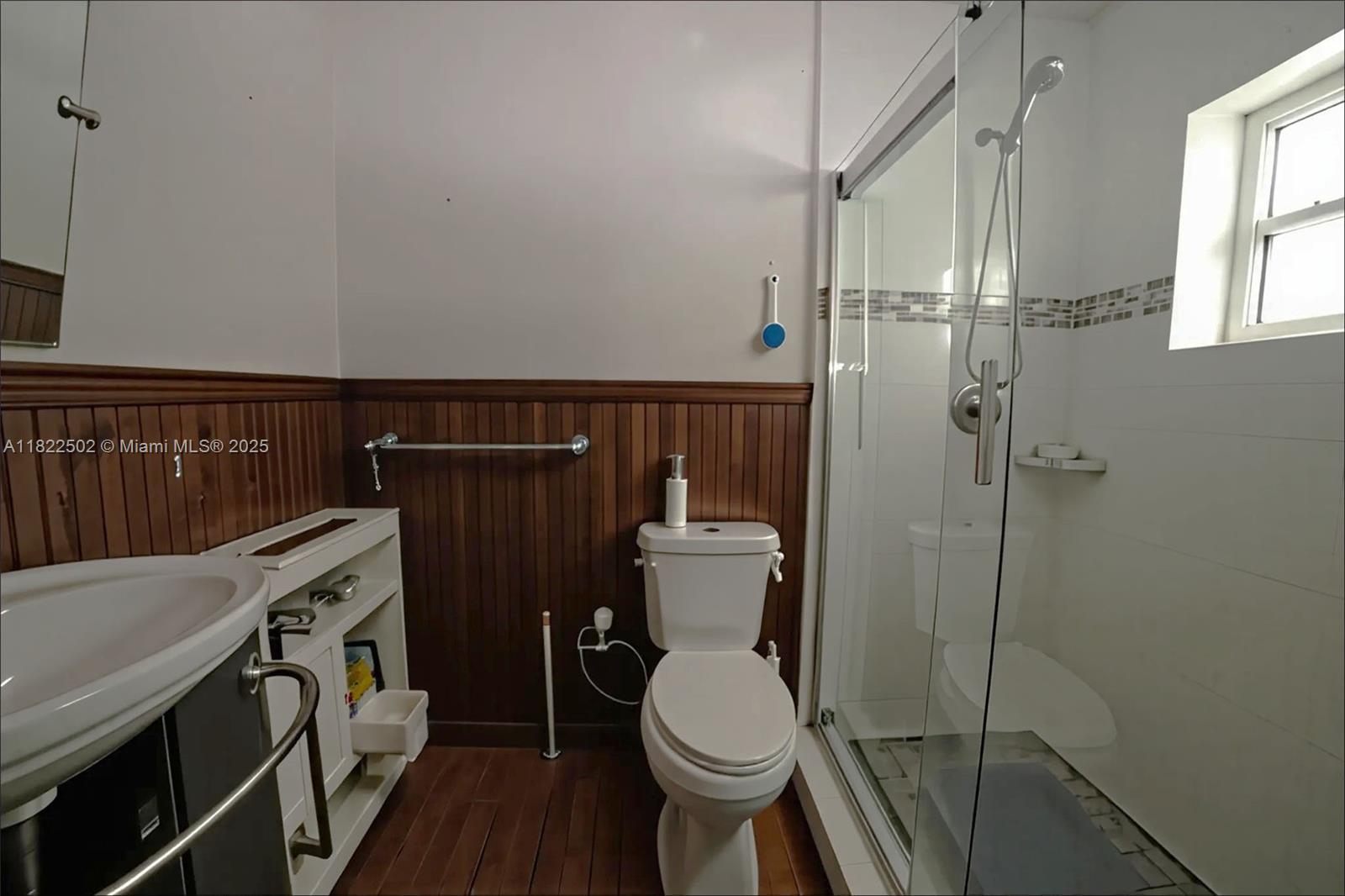 22115 Southwest 58th Avenue Boca Raton, FL 33428 - Photo 15 of 18 a bathroom with a toilet a sink and shower