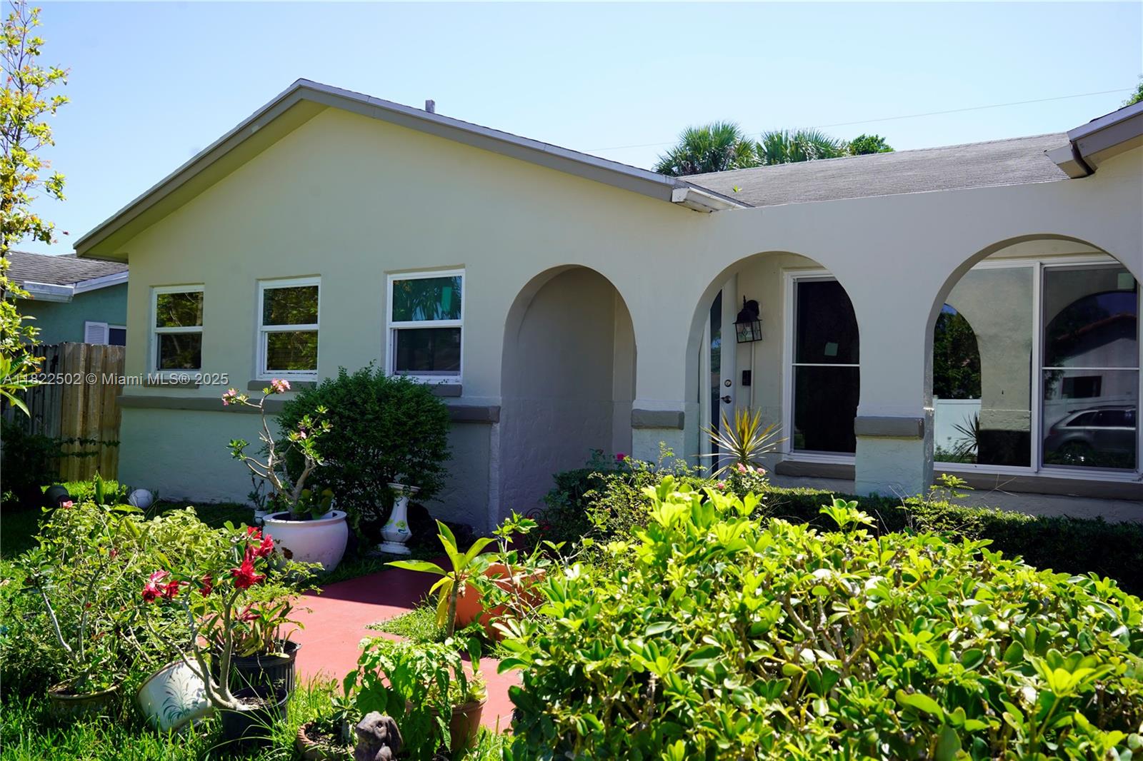 22115 Southwest 58th Avenue Boca Raton, FL 33428 - Photo 5 of 18 a front view of house and yard with beautiful flowers