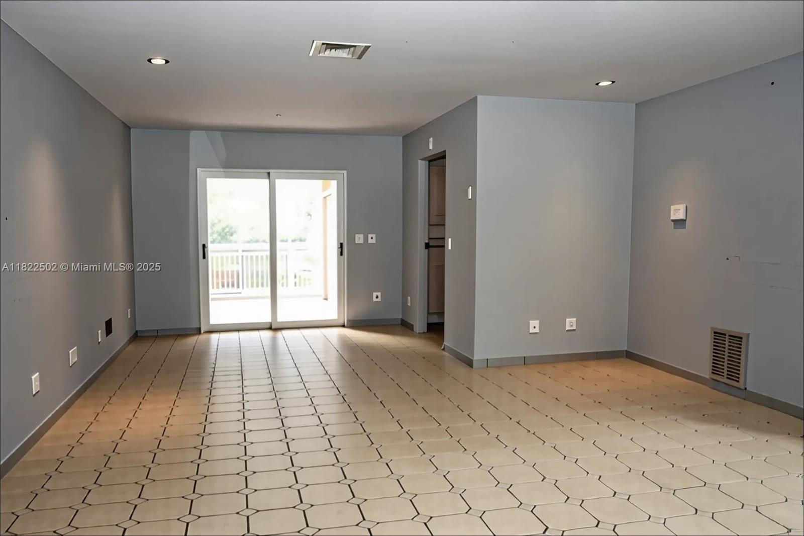 22115 Southwest 58th Avenue Boca Raton, FL 33428 - Photo 10 of 18 a view of an empty room with window and wooden floor