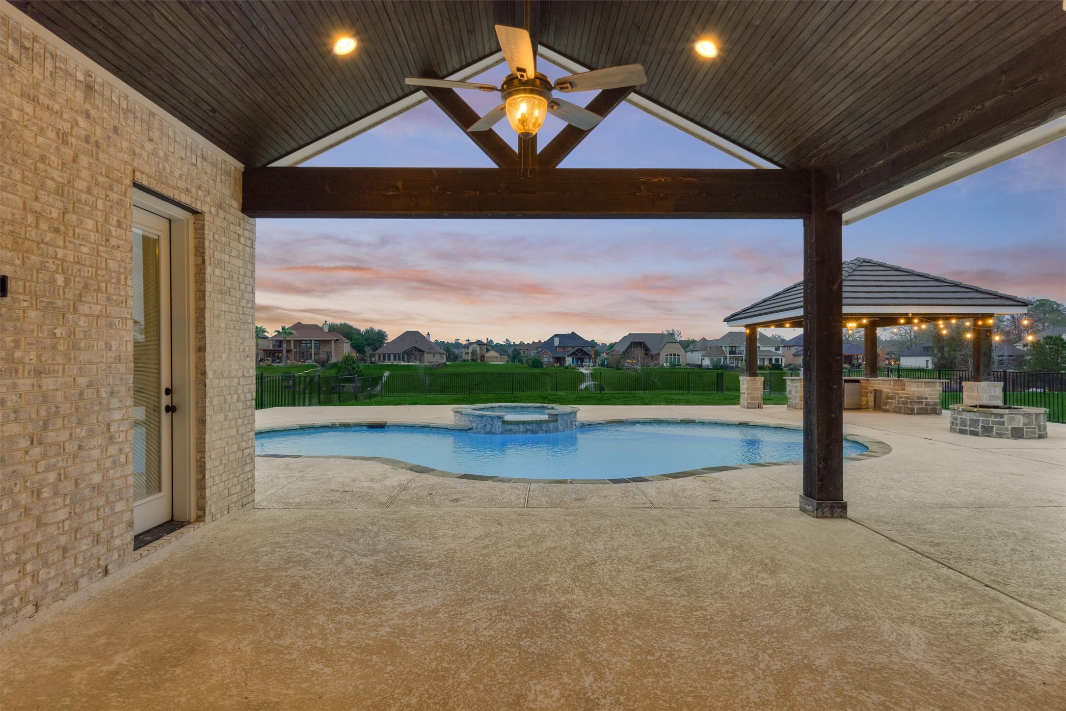 11618 Renaissance Drive Montgomery, TX 77356 - Photo 10 of 49 A glimpse of the back porch reveals views of the pool, outdoor kitchen, and fire pit for the perfect entertaining space. A convenient pool bath w/ shower is located just to the left.