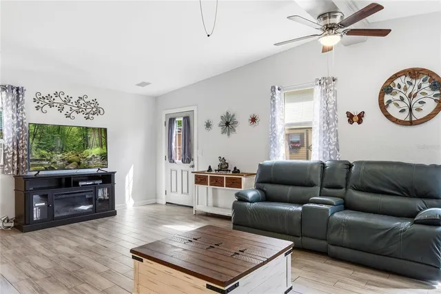 a living room with furniture a flat screen tv and a wall