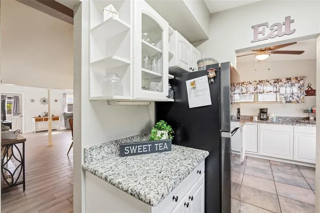 a kitchen with a granite countertop sink cabinets and window