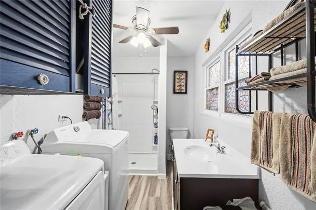 a white toilet sitting next to a bathroom sink