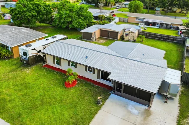 an aerial view of a house with swimming pool garden view and trees