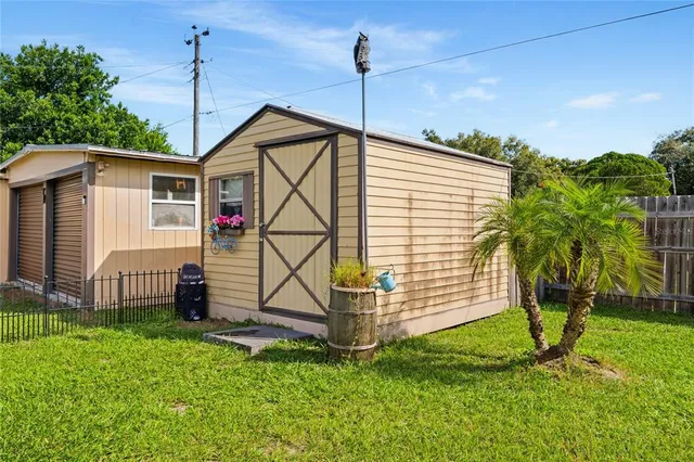 a view of a back yard with wooden fence