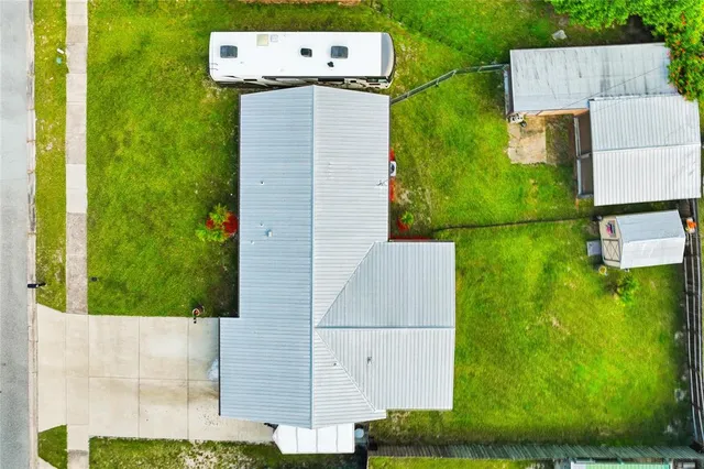 an aerial view of a house with a yard