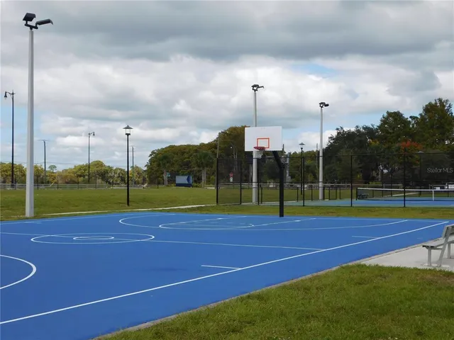 an aerial view of a residential houses with outdoor space and lake view