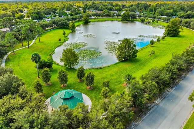an aerial view of a house with a yard and lake view