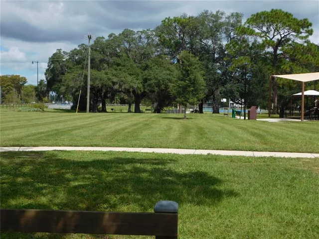 a view of a lake with a yard and trees