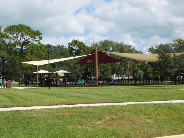 a patio with a table and chairs under an umbrella