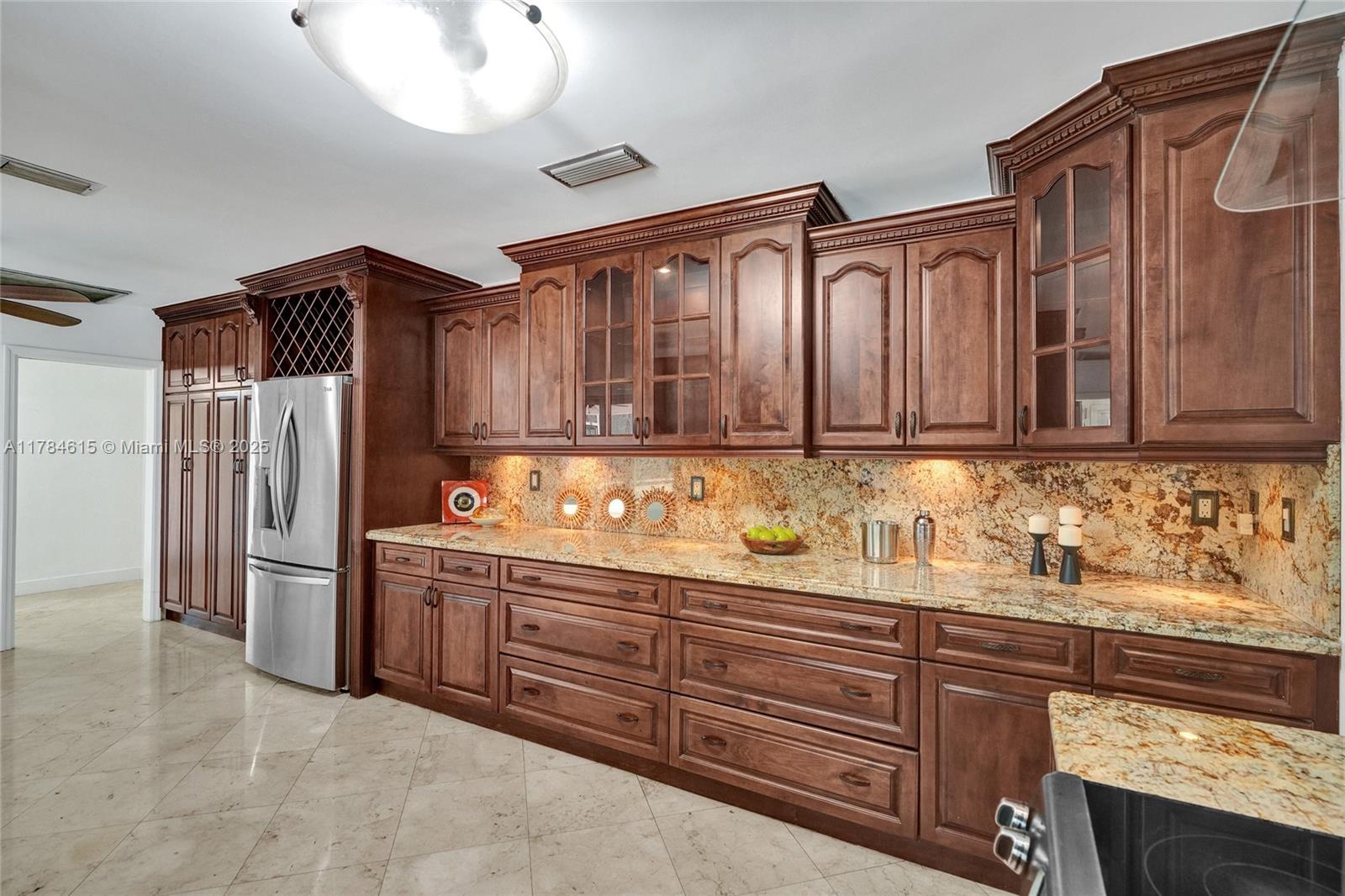 7360 Southwest 120th Street Pinecrest, FL 33156 - Photo 11 of 68 a kitchen with stainless steel appliances granite countertop a refrigerator and a sink