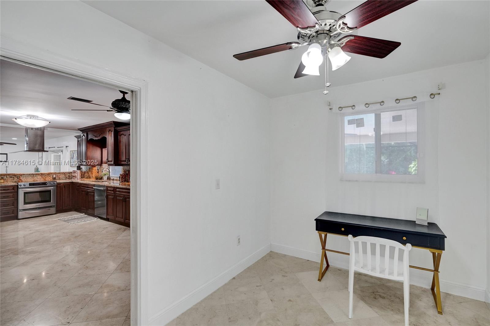 7360 Southwest 120th Street Pinecrest, FL 33156 - Photo 13 of 68 a kitchen with stainless steel appliances kitchen island granite countertop a refrigerator and a stove top oven