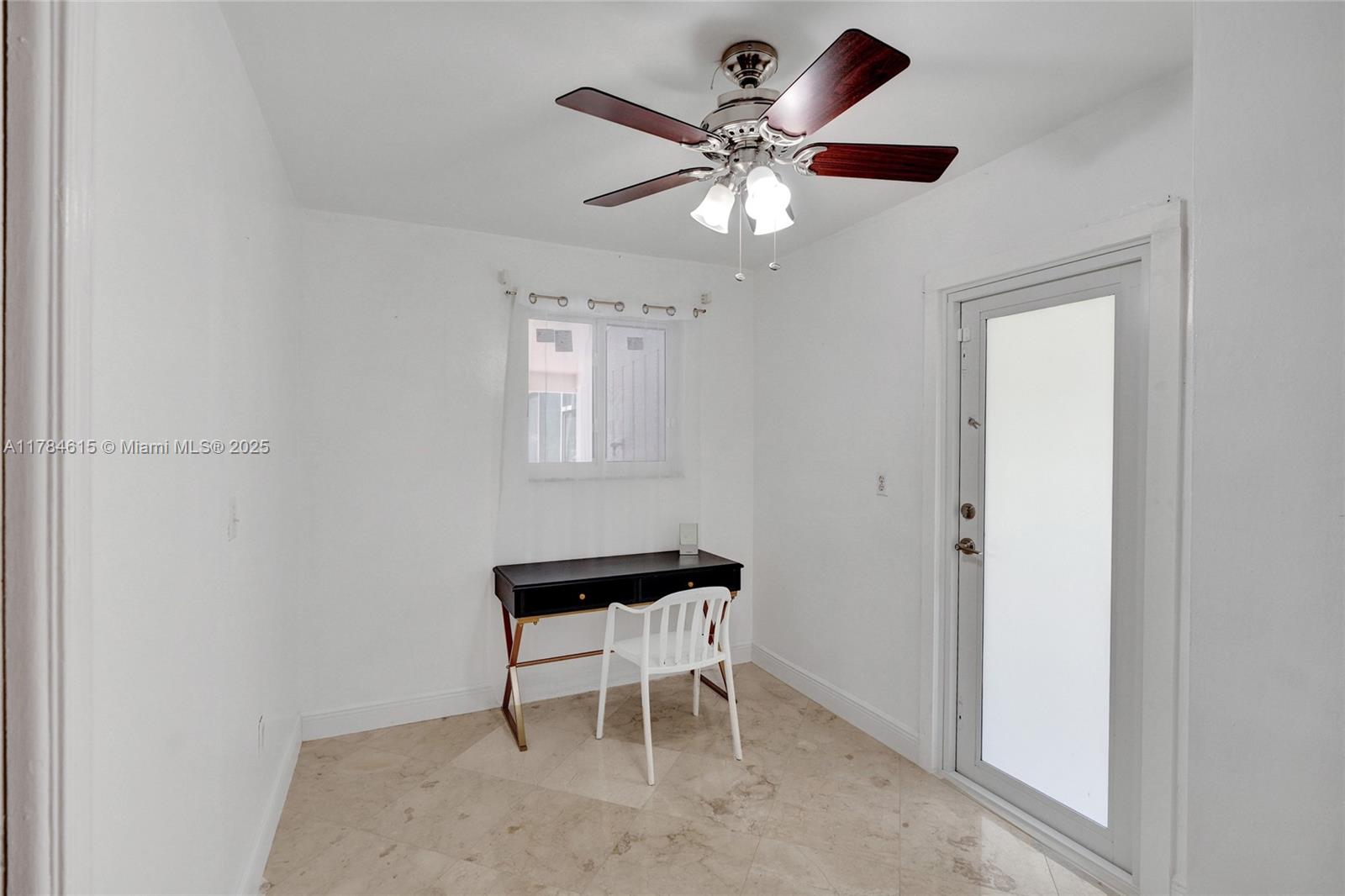 7360 Southwest 120th Street Pinecrest, FL 33156 - Photo 14 of 68 a view of a workspace with furniture and a window