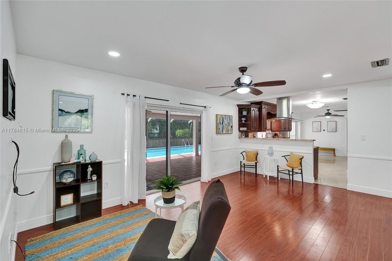 7360 Southwest 120th Street Pinecrest, FL 33156 - Photo 20 of 68 a living room with furniture and wooden floor