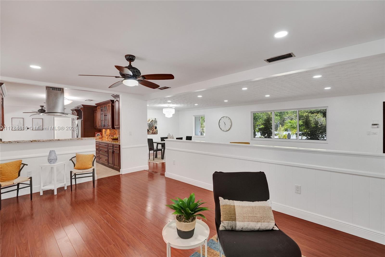 7360 Southwest 120th Street Pinecrest, FL 33156 - Photo 21 of 68 a living room with furniture and a wooden floor