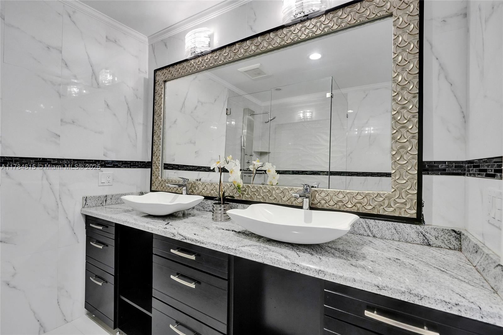 7360 Southwest 120th Street Pinecrest, FL 33156 - Photo 30 of 68 a bathroom with a granite countertop sink and a mirror