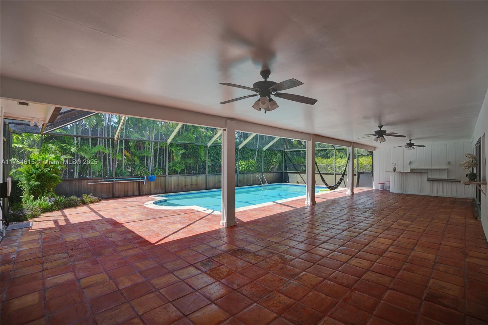 7360 Southwest 120th Street Pinecrest, FL 33156 - Photo 3 of 68 a room with pool and windows