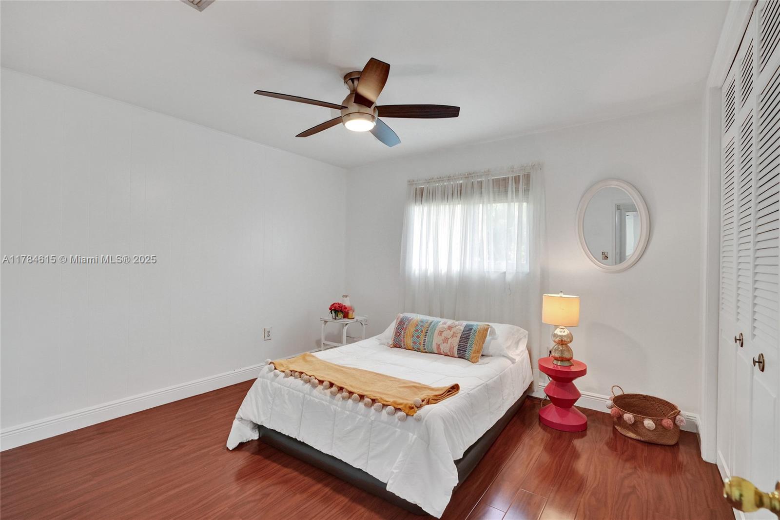 7360 Southwest 120th Street Pinecrest, FL 33156 - Photo 33 of 68 a bedroom with a bed and wooden floor