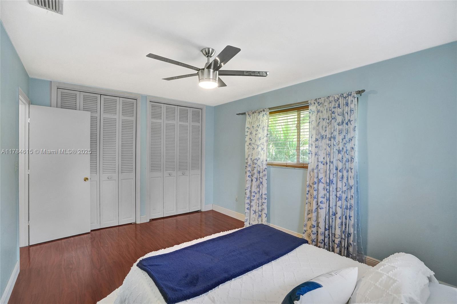 7360 Southwest 120th Street Pinecrest, FL 33156 - Photo 38 of 68 a bedroom with a bed and a window