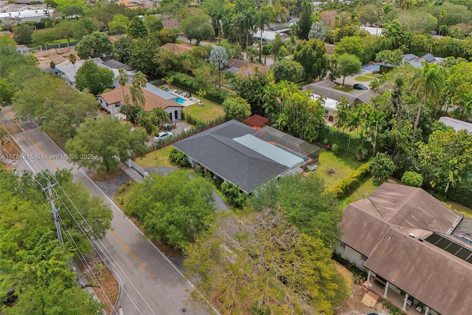 7360 Southwest 120th Street Pinecrest, FL 33156 - Photo 63 of 68 an aerial view of a house with a yard