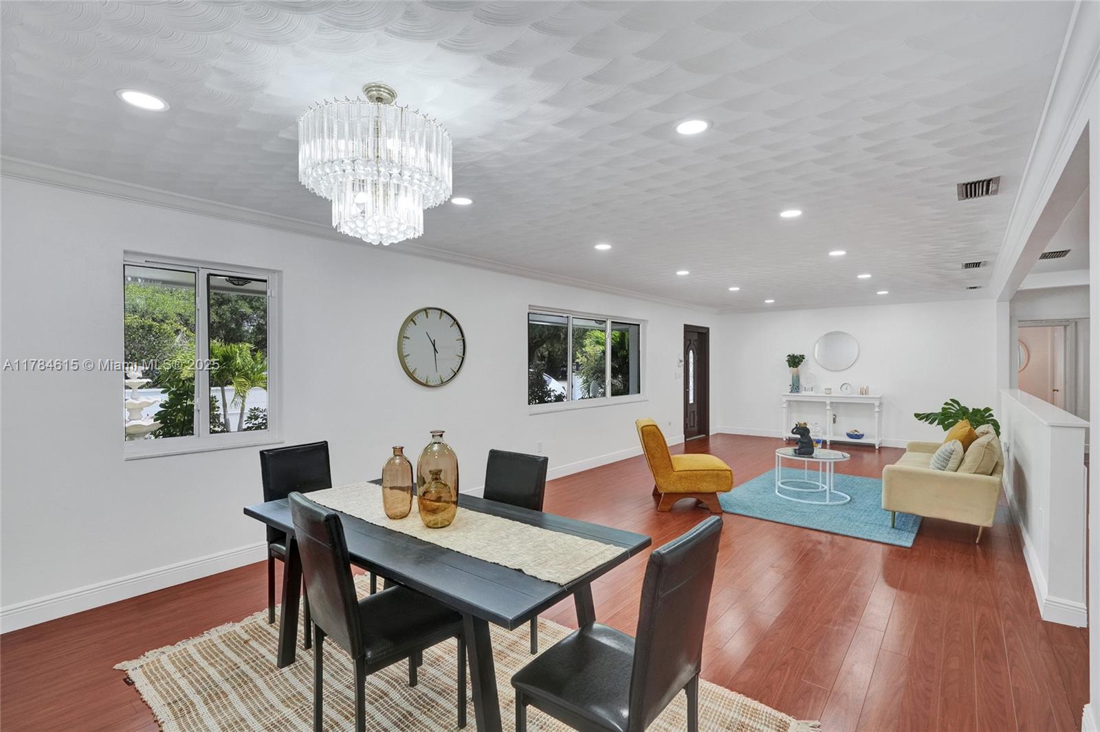 7360 Southwest 120th Street Pinecrest, FL 33156 - Photo 8 of 68 a view of a dining room with furniture a chandelier and wooden floor