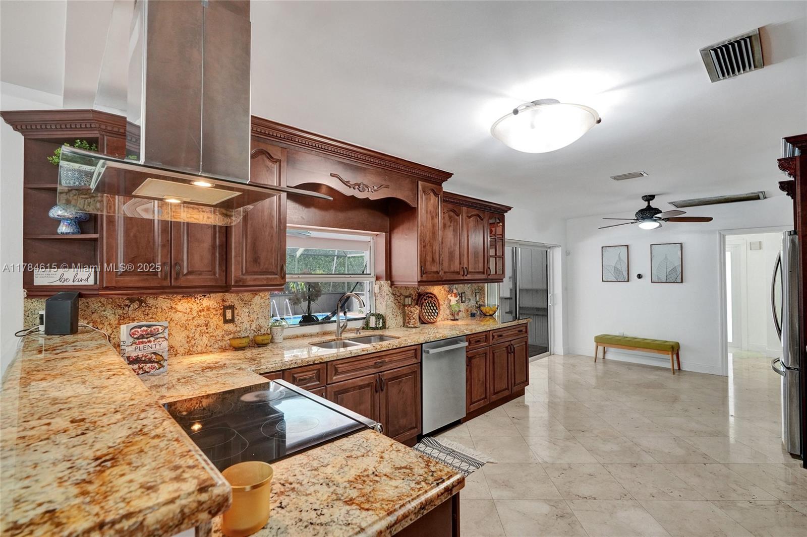7360 Southwest 120th Street Pinecrest, FL 33156 - Photo 9 of 68 a kitchen with a sink stove and cabinets