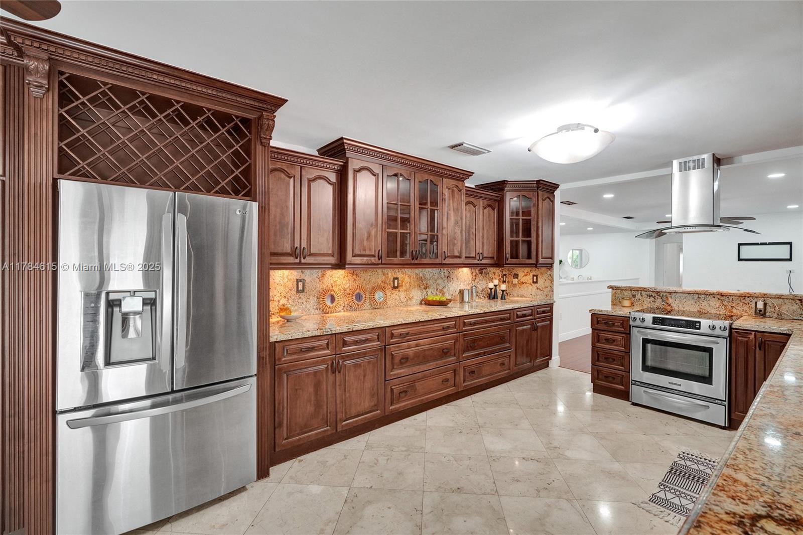 7360 Southwest 120th Street Pinecrest, FL 33156 - Photo 10 of 68 a kitchen with granite countertop stainless steel appliances and wooden cabinets