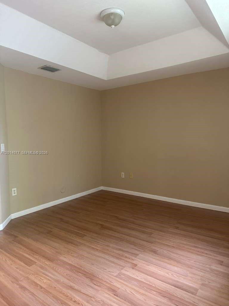 2913 Southeast 15th Road, Unit 64 Homestead, FL 33035 - Photo 13 of 14 a view of an empty room with wooden floor