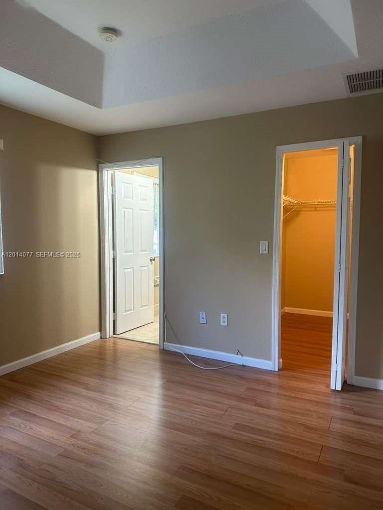 2913 Southeast 15th Road, Unit 64 Homestead, FL 33035 - Photo 14 of 14 a view of an empty room with wooden floor and a window