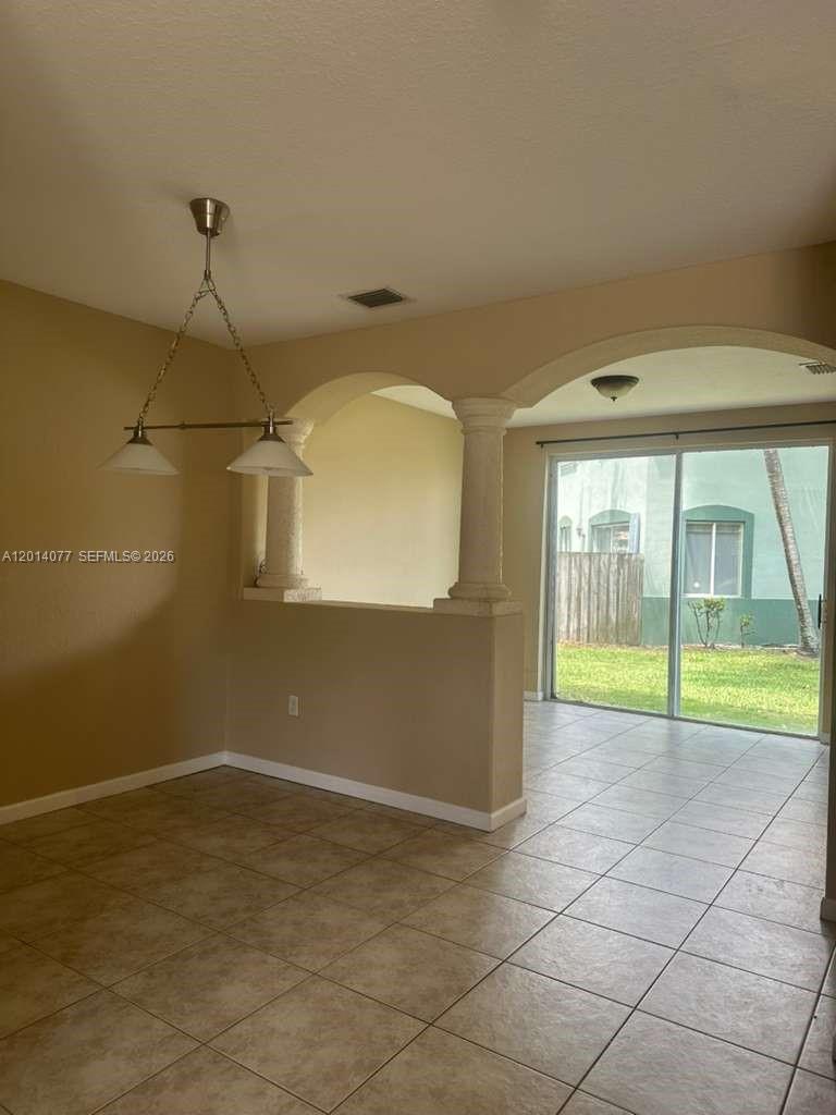 2913 Southeast 15th Road, Unit 64 Homestead, FL 33035 - Photo 4 of 14 a view of an empty room with a window