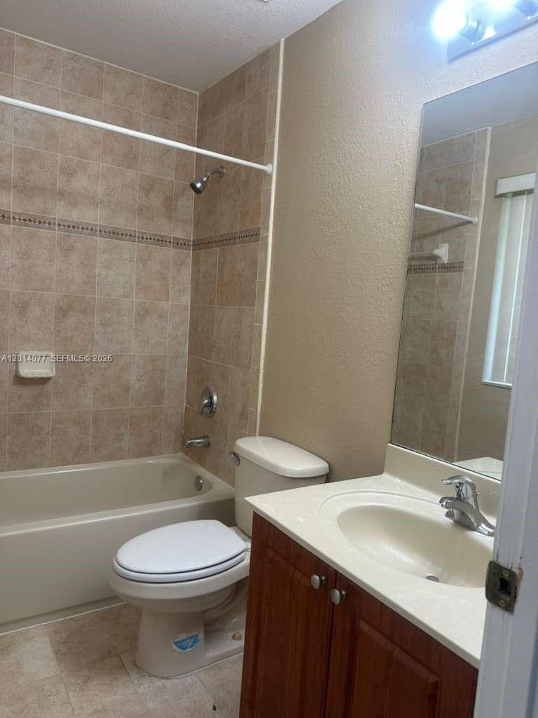 2913 Southeast 15th Road, Unit 64 Homestead, FL 33035 - Photo 5 of 14 a bathroom with a sink a toilet and shower